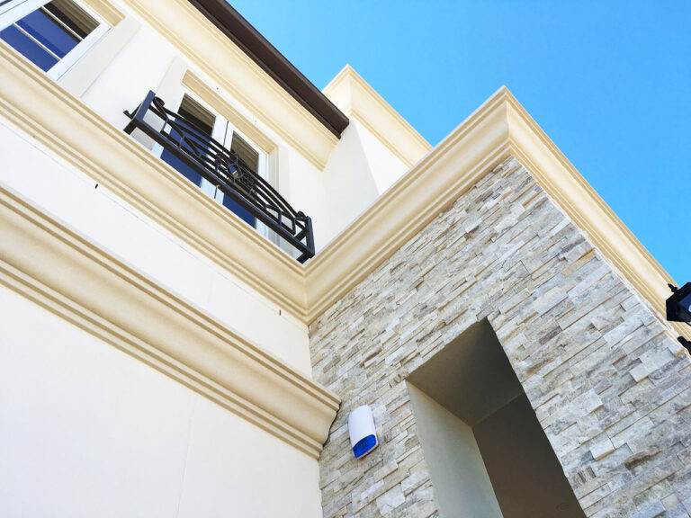 Custom parapet and soffit mouldings on a two-storey home Custom parapet and soffit mouldings on a two-storey home